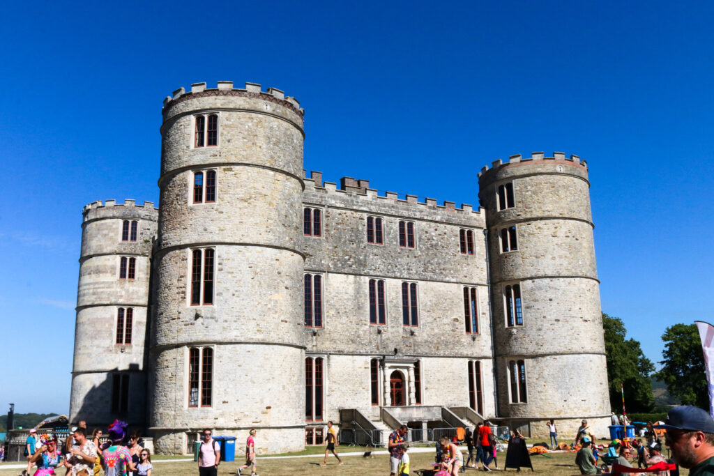 People walking past Lulworth Castle at Camp Bestival