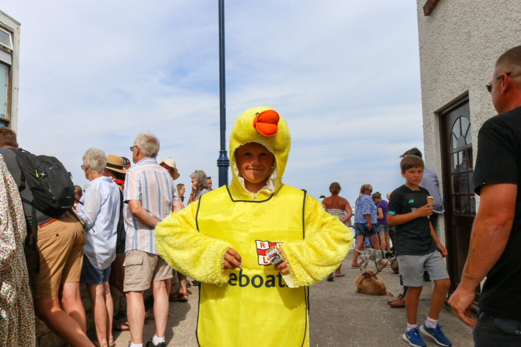 RNLI child volunteer dressed as a duck for the annual Swanage duck race