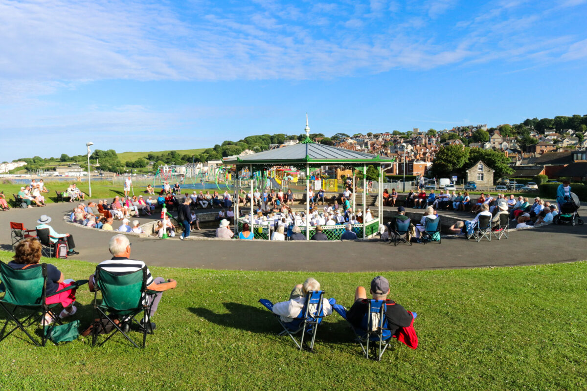 People listening to Swanage Town Band at the bandstand