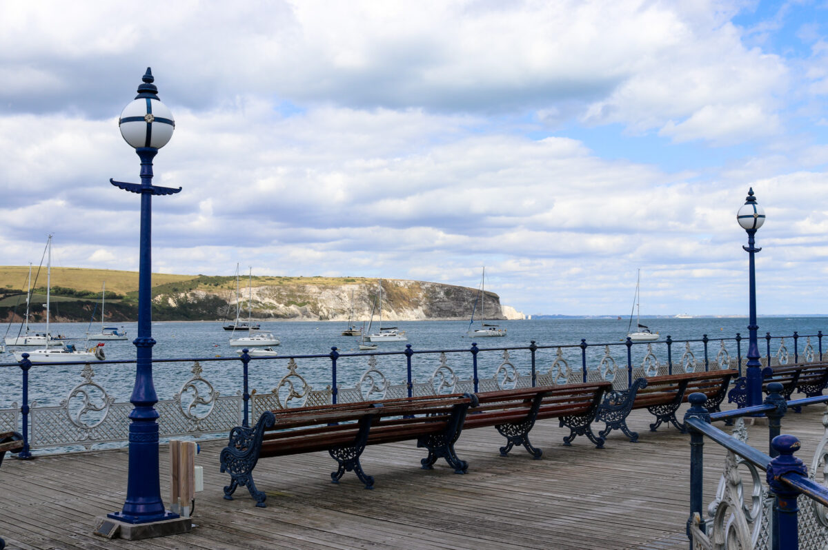 Victorian pier and benches looking out to Swanage's Ballard Down
