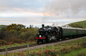 Swanage Railway steam train passing Corfe Castle